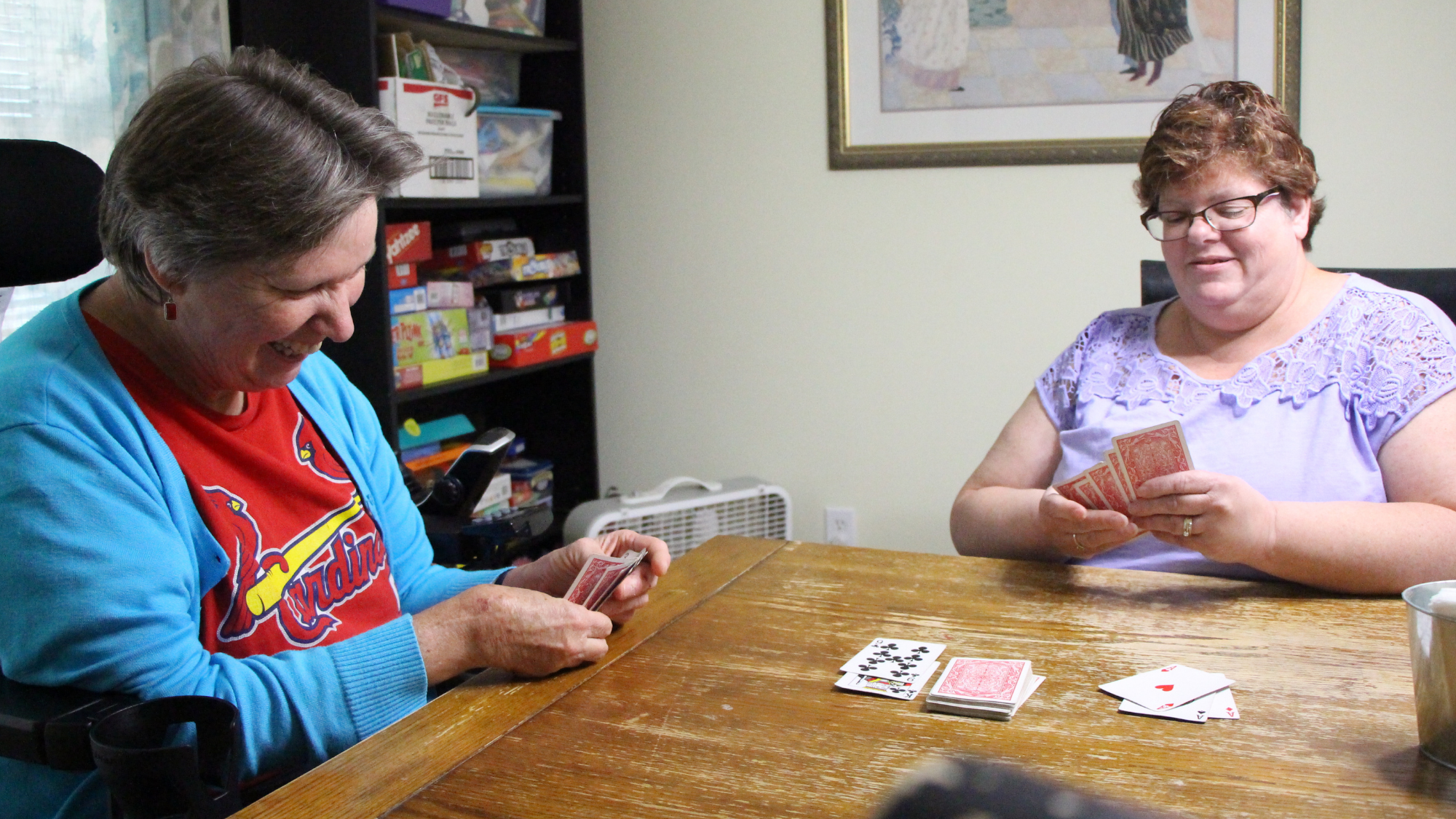Emmaus Team Member Shelly playing cards with Emmaus client
