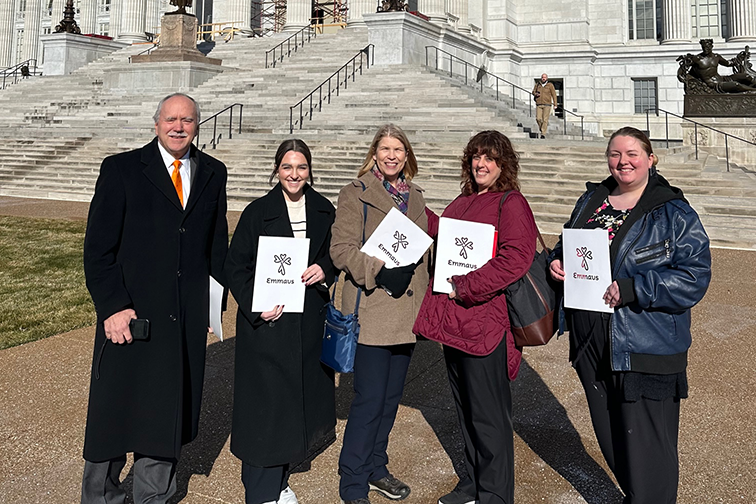 5 Emmaus Advocates pose in front of the Missouri State Capitol. Each is holding an Emmaus folder and smiling. Nancy Doresch is the woman in the center. Among the group is former State Senator Chuck Gross and one of our Emmaus Direct Support Professionals!