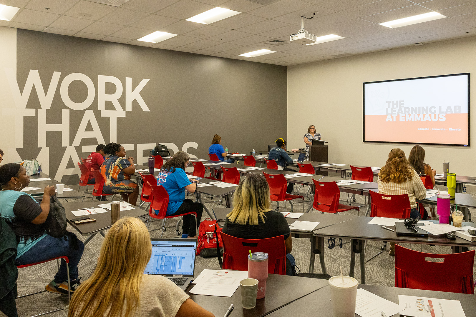 Training session in progress at The Learning Lab at Emmaus with attendees seated at desks and a presenter at the podium.