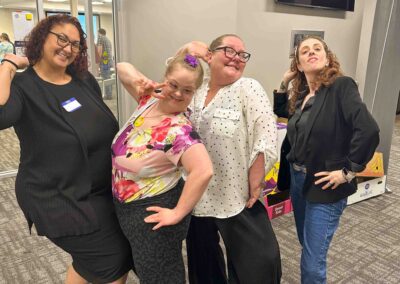 Four women stand together striking dramatic and silly poses after the workshop.