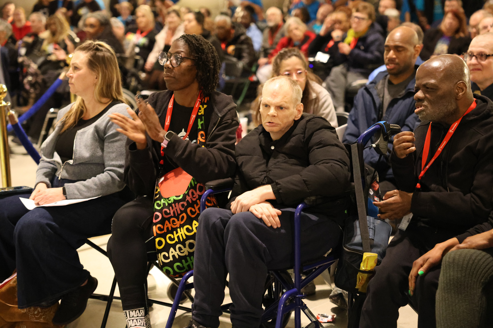 Emmaus participants and advocates sit together at Disability Rights Legislative Day, listening and applauding during a gathering at the Missouri Capitol.