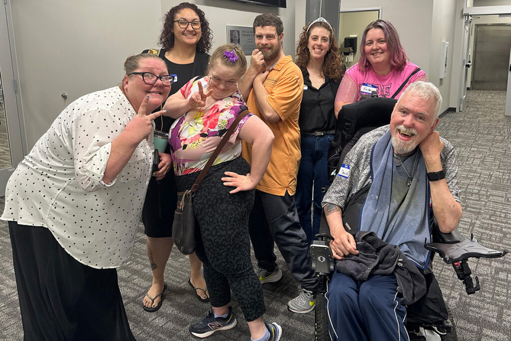 Group of Emmaus clients and staff posing happily at the MOAAIDD storytelling workshop.