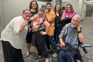 Group of Emmaus clients and staff posing happily at the MOAAIDD storytelling workshop.